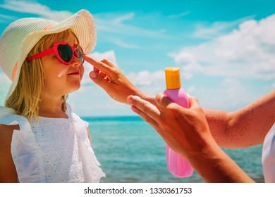 Sun Protection - Mom Put Suncream On Little Girl Face At Beach