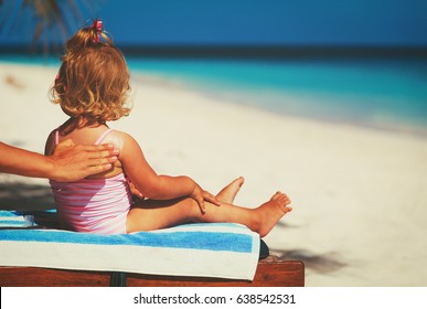 Sun Protection -mother Applying Sunblock Cream On Child Shoulder