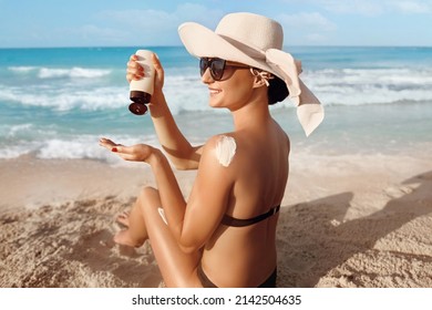 Sun Protection. Skin and Body Care. Girl Using Sunscreen to Skin. Beautiful Woman in Bikini Applying Sun Cream on Tanned  Shoulder.  - Shutterstock ID 2142504635