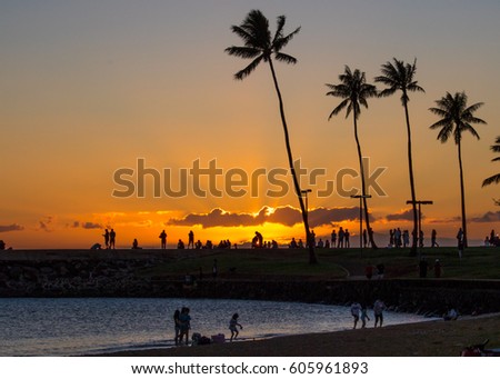 Sun ray breaking through the clouds at sunset, Ala Moana Beach Park, Hawaii, USA