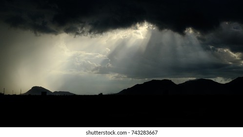 Sun ray,crepuscular rays: streaming through gaps in clouds are parallel columns of sunlit air separated by darker cloud shadowed regions.  dust, aerosol scatter the sunlight and mark the ray visible.