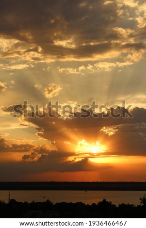 Sun rays beetween the clouds in a sunset sky