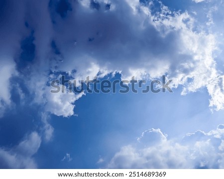 sun rays and blue sky with clouds