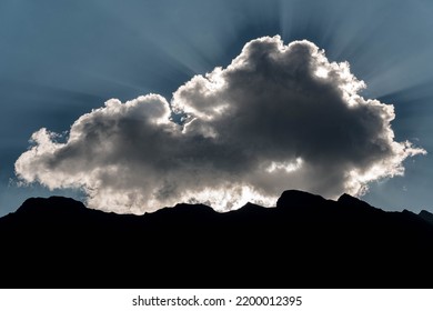 Sun Rays Break Through The Clouds In Switzerland Alps.