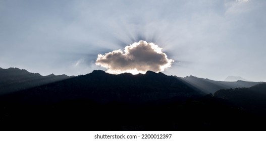 Sun Rays Break Through The Clouds In Switzerland Alps.