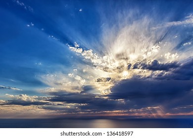 Sun rays breaking through the clouds at sunset