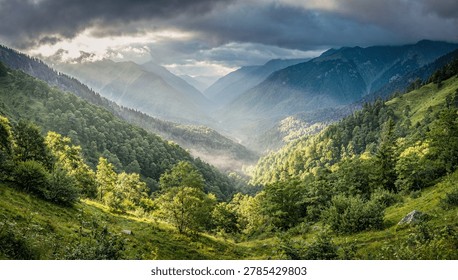 Sun Rays Breaking Through Clouds Over Lush Green Mountain Valley Landscape