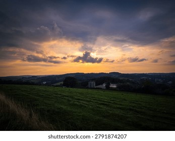 Sun rays breaking through clouds over hills
- Sun rays break through dramatic clouds over rolling hills and open countryside.
