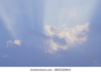 Sun Rays Breaking Through Clouds in Sky