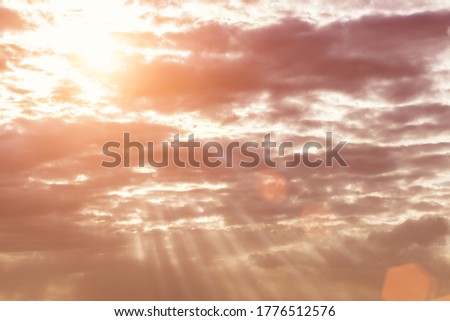 Sun rays breaking through cumulus clouds. The concept of divine light, a glimmer of hope or overcoming difficulties. Spiritual religious abstract background.