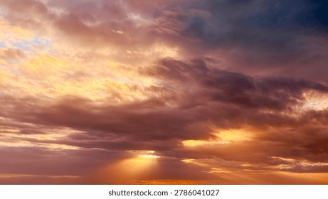 Sun Rays Breaking Through Dramatic Clouds at Sunset