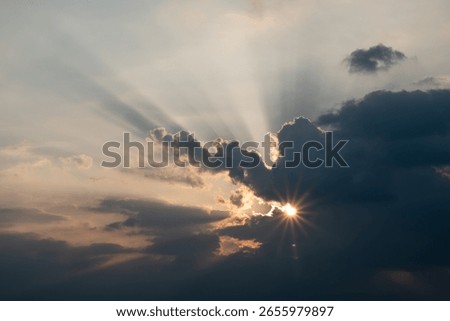 Sun Rays Breaking Through Dramatic Clouds at Sunset