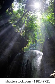 Sun rays in a cave with falls. Jamaica
