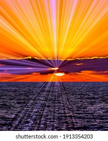 Sun Rays Emanate From Behind the Clouds as the Sun Sets on the Ocean Horizon