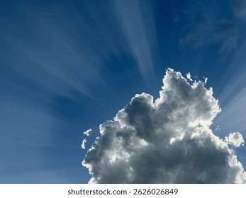 Sun rays emerging from behind a cloud