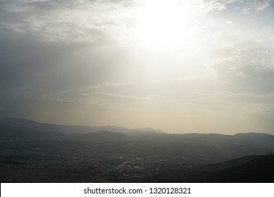 Sun rays escaping through the clouds of a village