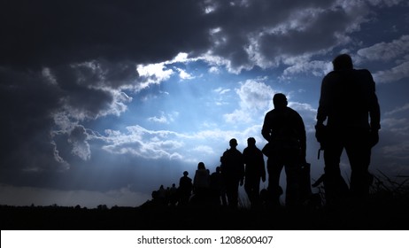 Sun rays illuminate people. Immigration of people. - Shutterstock ID 1208600407
