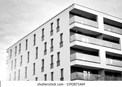 Sun rays light effects on urban buildings. Fragment of modern residential apartment with flat buildings exterior. Detail of new luxury house and home complex. Black and white.