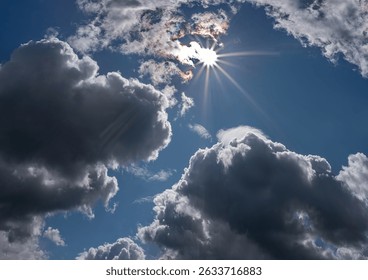 sun rays on a background of blue sky and cumulus clouds