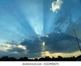 Sun rays peaking over clouds at sunset - Powered by Shutterstock - Get 15% off with code: PIKWIZARD15