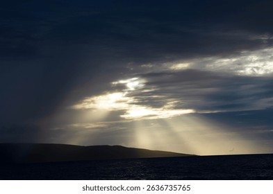 Sun Rays Peaking Through Clouds