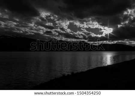 Sun Rays Peaking Through Clouds as the Sun Begins to Set Over Grand Teton Mountain Range - Black and White - Grand Teton National Park - Wyoming, United States