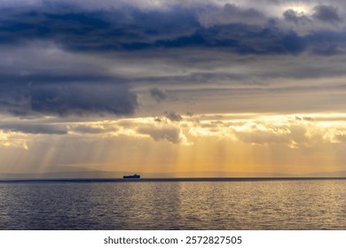 Sun rays peaking through the dark clouds on a ship floating in the adriatic sea creating a dramatic effect - Powered by Shutterstock - Get 15% off with code: PIKWIZARD15