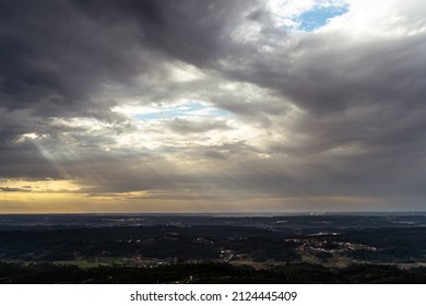 Sun Rays Piercing Through A Cloudy Sky, Seen From A Mountain Top