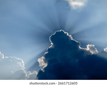 Sun Rays Piercing Through Dark Storm Clouds