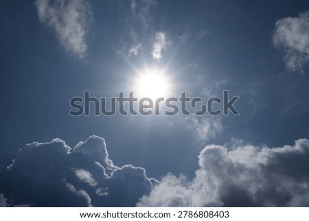 Sun rays. The sun shinning brightly between the clouds during the day.