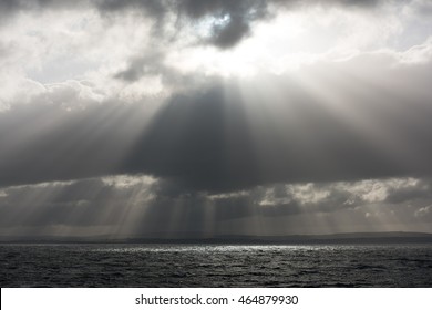 sun rays streaming through the storm clouds on the Irish Ocean - Powered by Shutterstock - Get 15% off with code: PIKWIZARD15