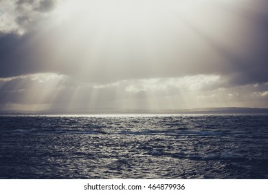 sun rays streaming through the storm clouds on the Irish Ocean - Powered by Shutterstock - Get 15% off with code: PIKWIZARD15