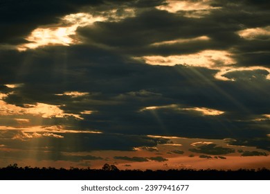 sun rays through black clouds