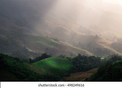 sun rays through the clouds over mountains,