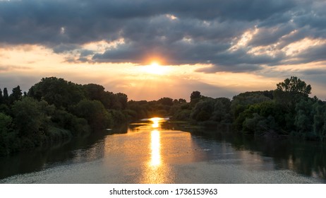 The Sun Is Reflected In The Water As It Goes Down. River Ter, Catalonia.