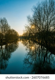 the sun reflection in the quieter river eure ealy in the morning