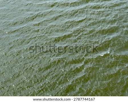 The sun reflects off whitecaps during strong winds on the Schuylkill River in Philadelphia.