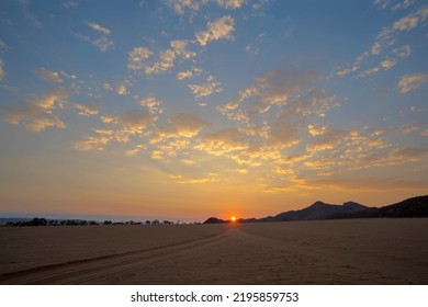 Sun Rise On The Horizon Where Two Sand Tracks Join Namib Desert Namibia