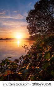 Sun Rise Over River Corrib, Galway City, Ireland. Rich Warm And Cool Colors. Sky And Sun Reflection In Water Surface. Amazing Nature Scene Landscape. Calm And Peaceful Mood.