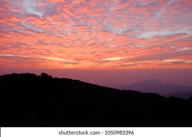 Sun Rise Purple Orange Sky Background With Landscape Of Mountain And Tree With Cloudy Sky