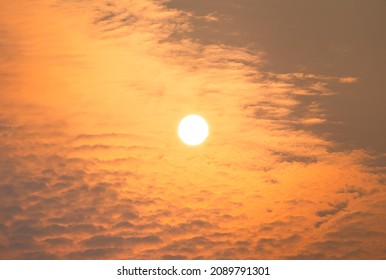 The Sun Rises Above Some Clouds On A Hazy Summer Morning.