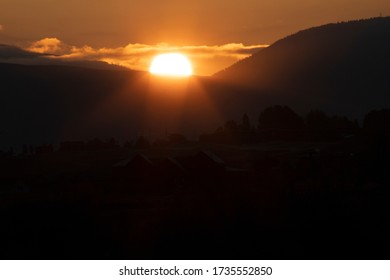 The Sun Rises Between Two Mountains In Missoula, Montana.