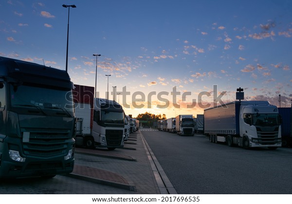 Sun rises\
over a truck parking lot on the\
highway