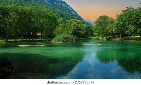 the sun rises in spring on the small lake in the wild forest