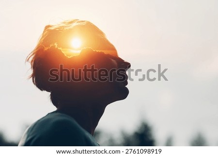 Sun rising above the clouds inside the silhouette of a male head. The way of thinking and psychology of successful man. Positive mindset of businessman concept.