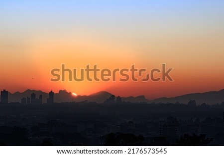 Similar – Image, Stock Photo The sun rises behind a concrete wall. The wall reads, “Enjoy more overtimes.”