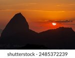 sun rising behind the silhouette of Sugarloaf Mountain in Rio de Janeiro