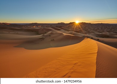 Sun is rising in the desert . Sunrise desert landscape photo was taken in Erg Chebbi near Merzouga, Saharan Morocco.