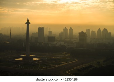 The Sun Rising In National Monument Of Indonesia Located In Jakarta