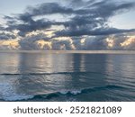 Sun rising over a calm oceanscape